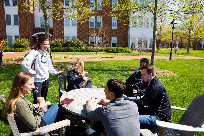 Students gathered around campfire